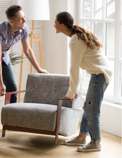 Couple moving furniture | Redd Flooring & Design Center