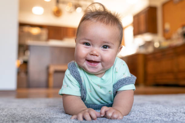 Baby lying on carpet floor | Redd Flooring & Design Center